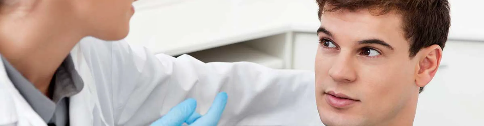 A dentist explaining treatment to a patient.