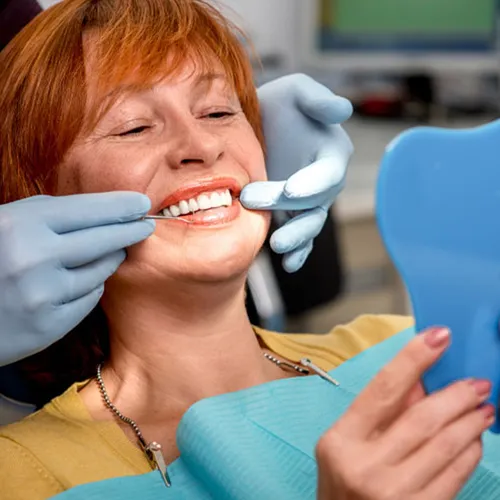 A woman smiling while getting a dental check-up.
