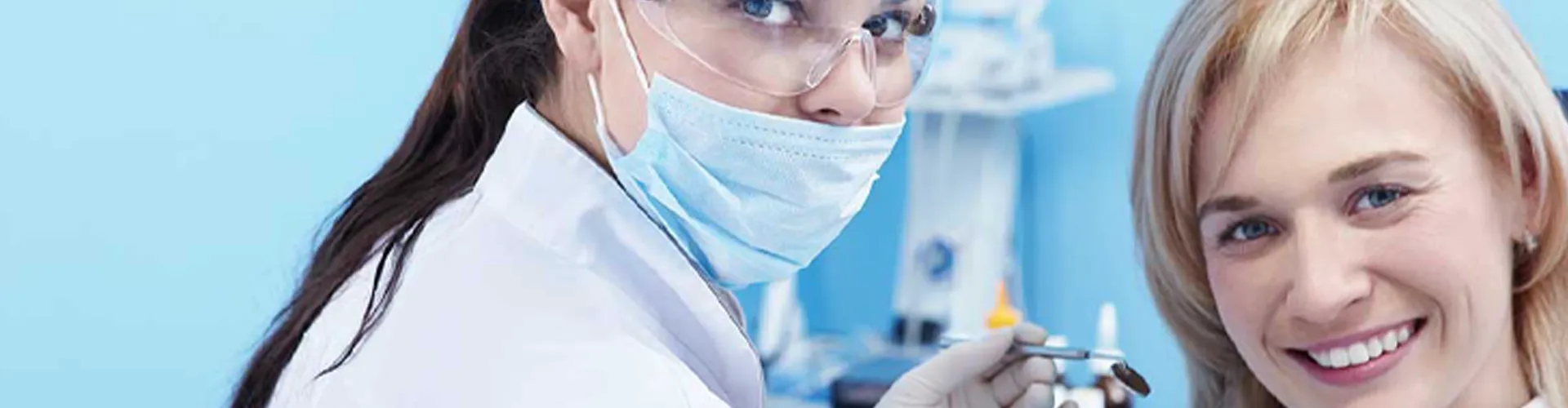 A woman and the dentist smiling.